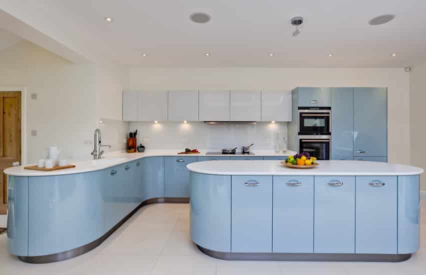 Baby blue modern kitchen with white counters and flooring