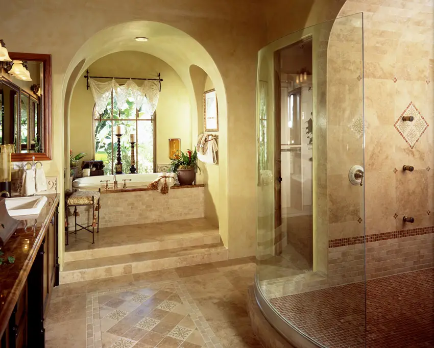Bathroom with mosaic tilework and arched ceiling