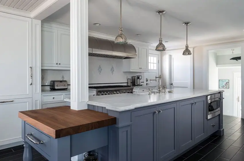 White countertop on blue working island and pendant lights
