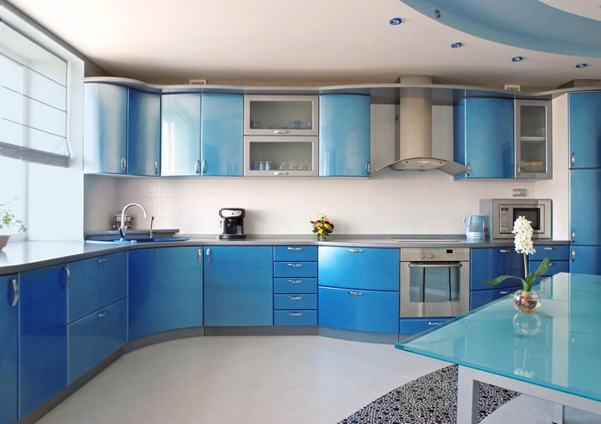 Blue modern kitchen with white tile back splash