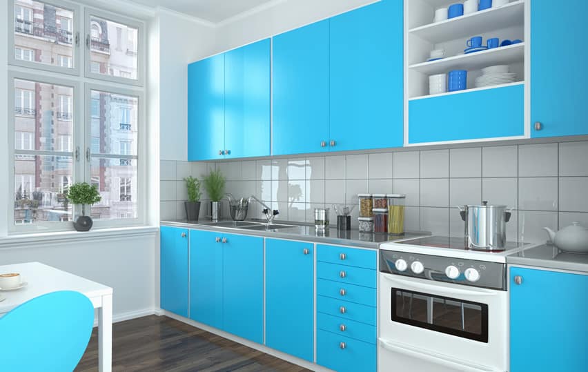 Bright blue modern kitchen with square tile back splash