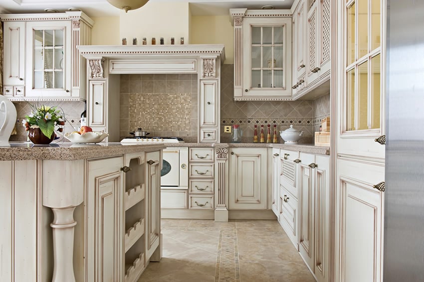 Custom white kitchen with tile backsplash and granite counter
