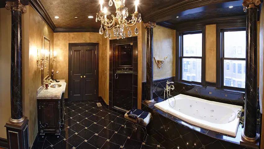 Bathroom with black wood cabinetry and crystal chandelier