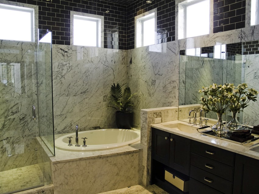 Very large bathroom with upper wall in black subway tile