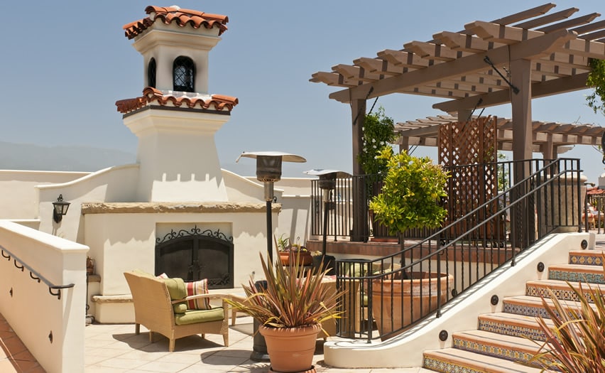Grand spanish style outdoor fireplace with stucco