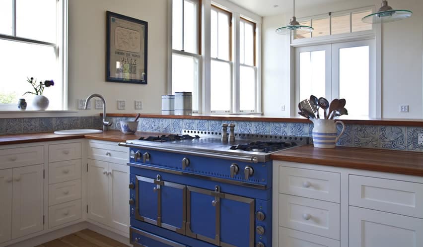 Kitchen with blue color gas stove and blue back splash