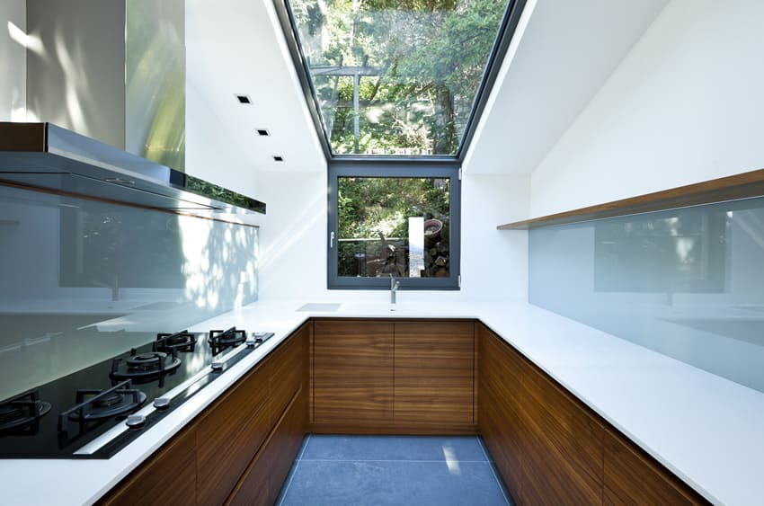 Kitchen with skylight and blue floor and back splash