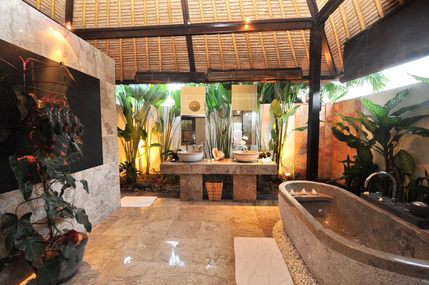 Luxury resort bathroom in tropical setting with vaulted ceiling