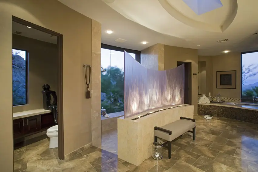 Bathroom with separate bath and shower areas and granite tiles