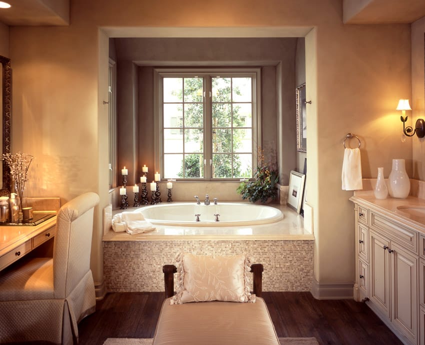 Romantic bathroom design with soft lighting and tile tub surround