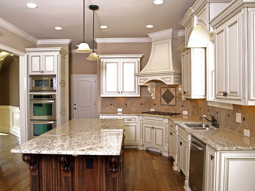 Rustic white kitchen cabinetry with granite island