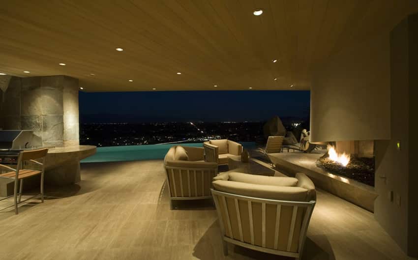 Stylish luxury patio with outdoor fireplace and city view