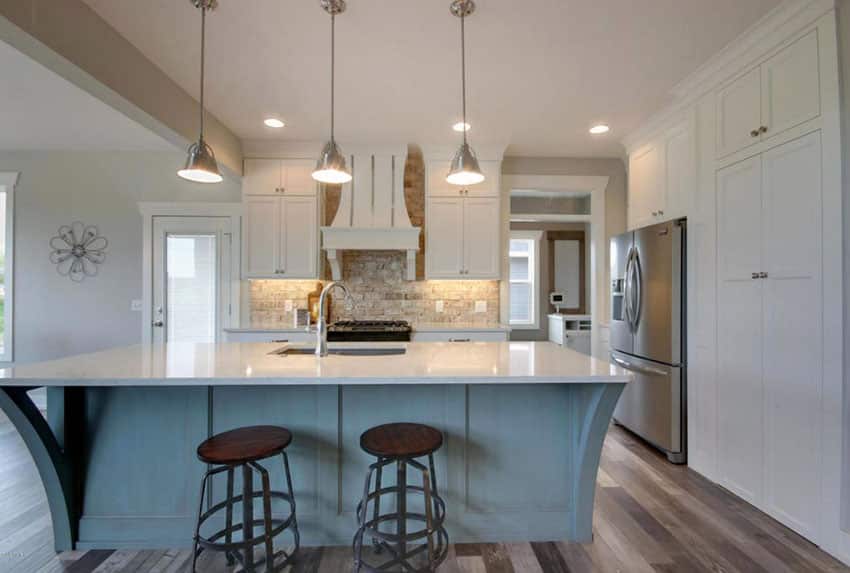 Traditional kitchen with white cabinets and blue painted island