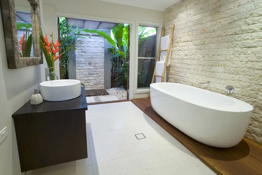 Tropical bathroom with private outdoor shower