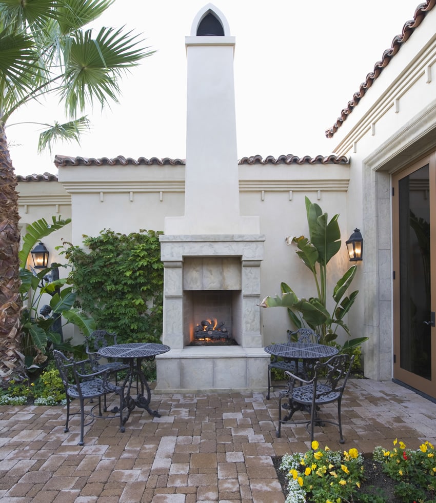 White outdoor fireplace with tall chimney