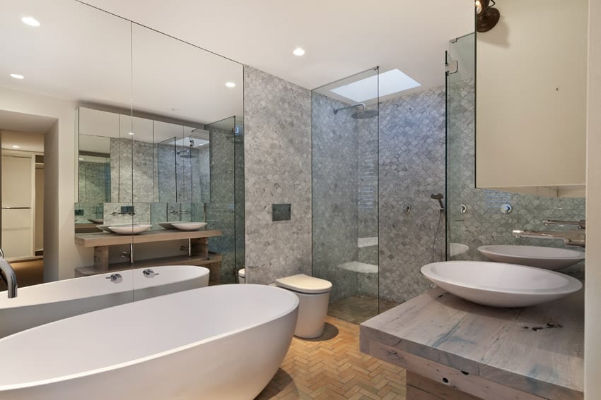 Bathroom with intricate tilework, large bathtub and basin sinks