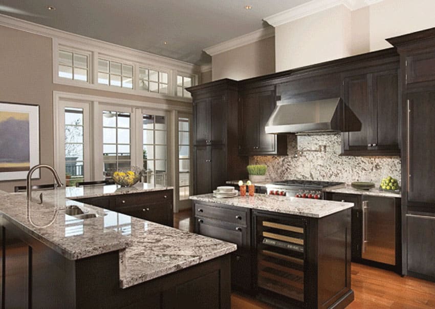 Beautiful dark wood cabinet kitchen with light color granite counters and stainless fixtures