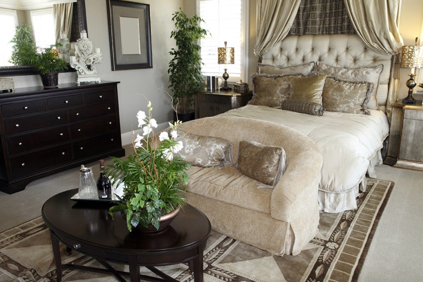 Master bedroom with double bed chair and dark wood furniture