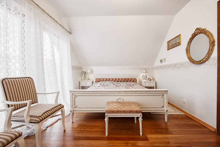 Bright white bedroom with wood floor