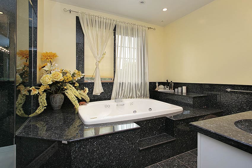 Master bath in luxury home in back marble