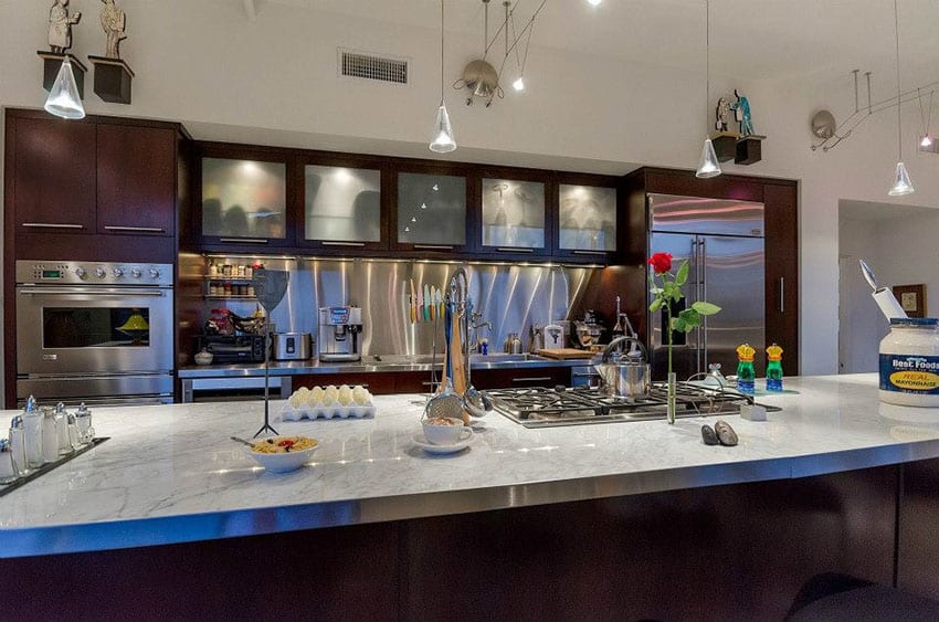 Kitchen with chrome appliances and counter top stove