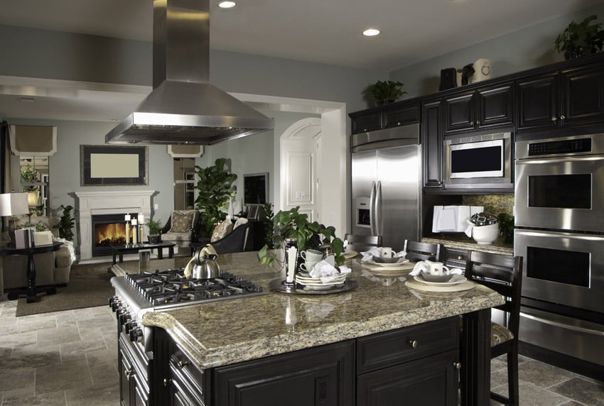 Open layout kitchen with paneled cabinets with dark gray duco finishing