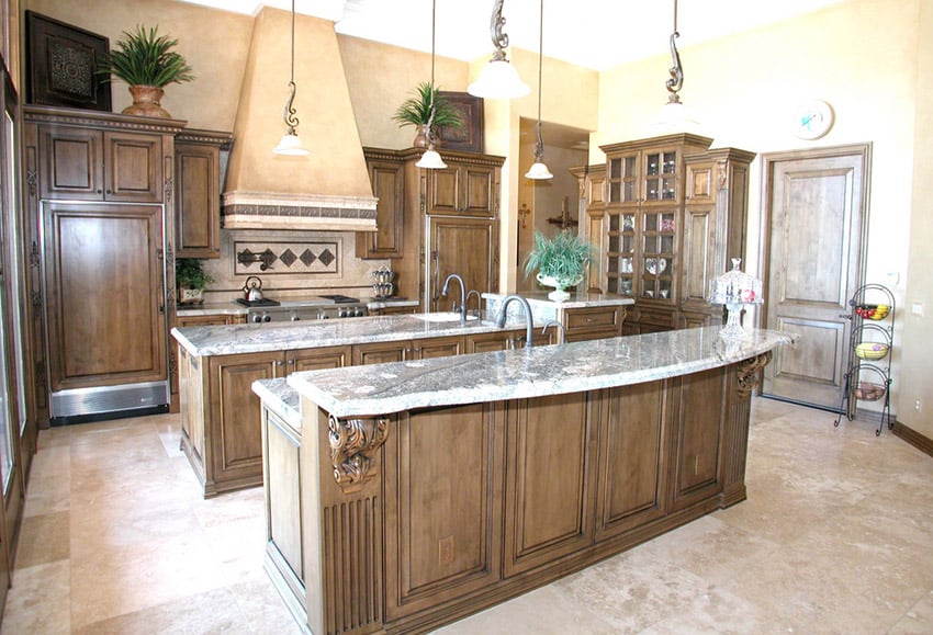 Rich wood decorative cabinets in the kitchen and travertine floor tiles