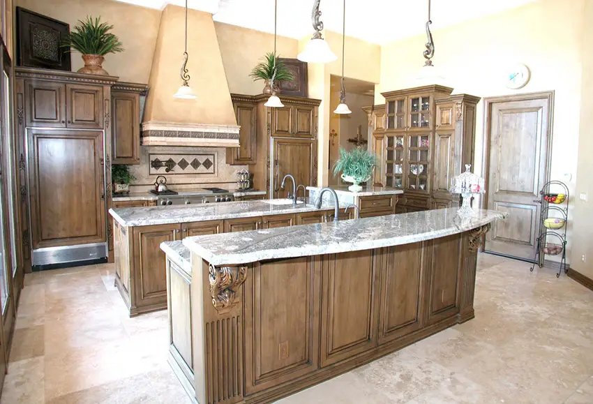 Rich wood decorative cabinets in the kitchen and travertine floor tiles