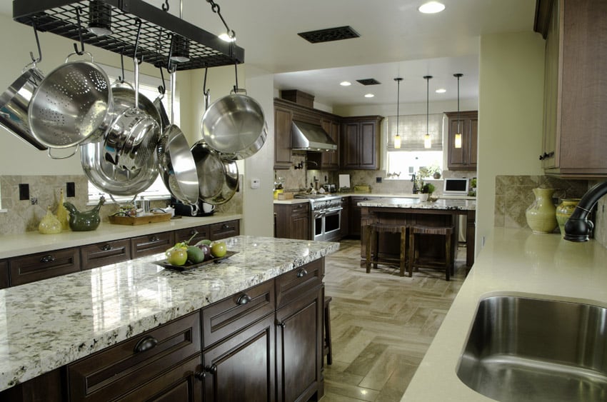 Dark wood cabinet kitchen with light color granite counters