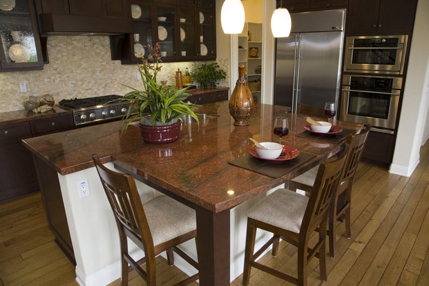 Dark wood kitchen with red granite counter