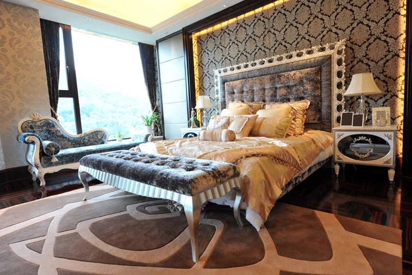 Brocade accent wall, classic chaise lounge and taupe carpet