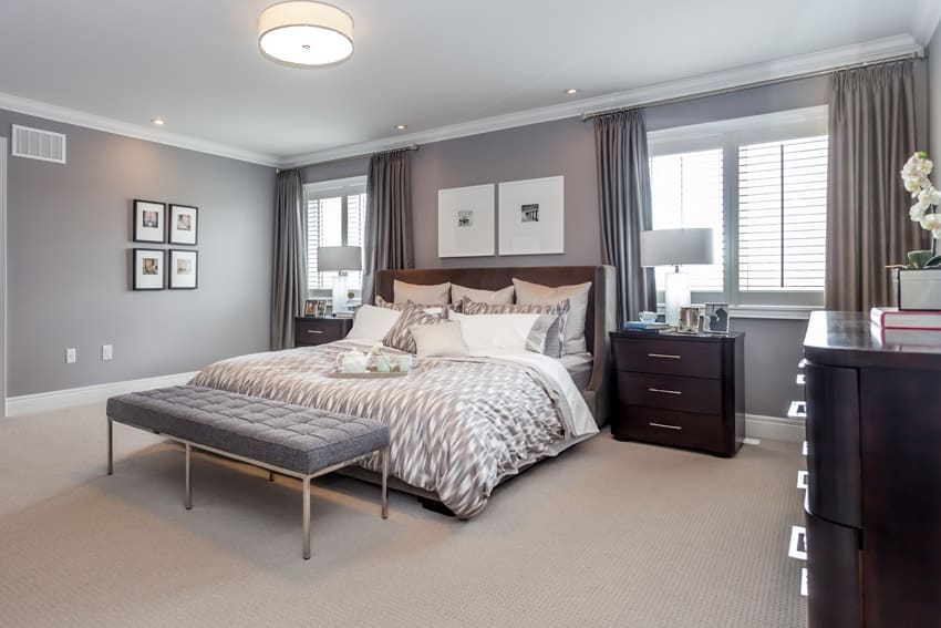 Grey walls, tan carpet and wing bed