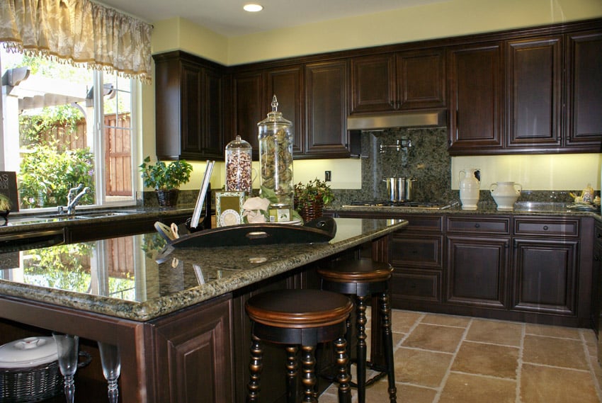 Intricate wood and granite kitchen island with green granite