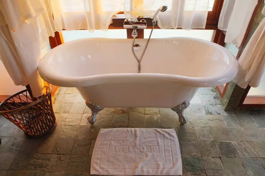 Inviting bathtub on natural stone floor