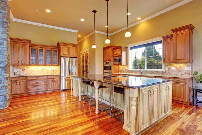 Kitchen with highly polished wood flooring white island