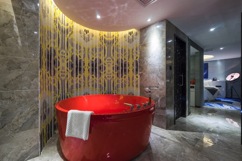Large red tub in decorated bathroom