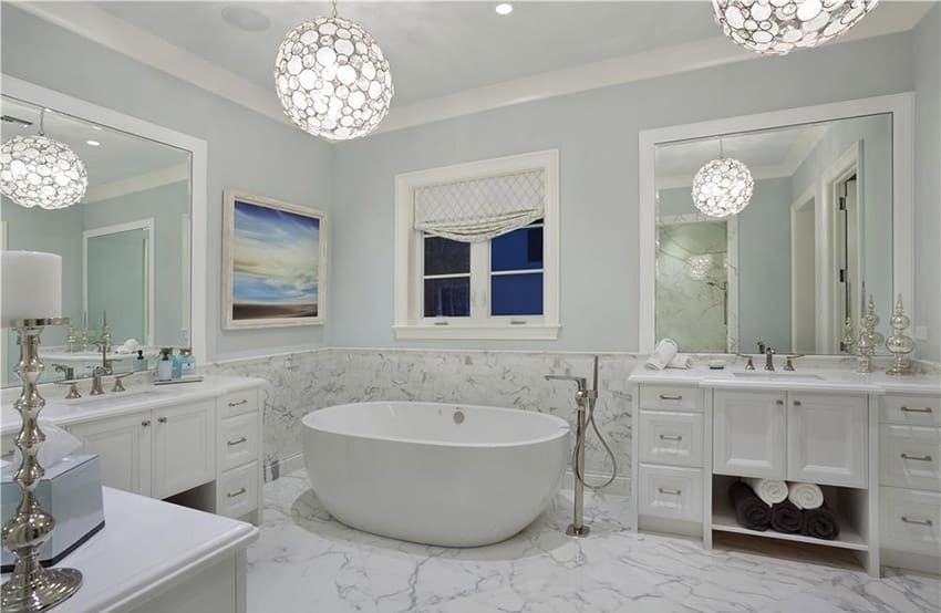 Master bathroom with white marble and globe lighting