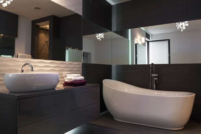 Mirrored bathroom interior with bathtub