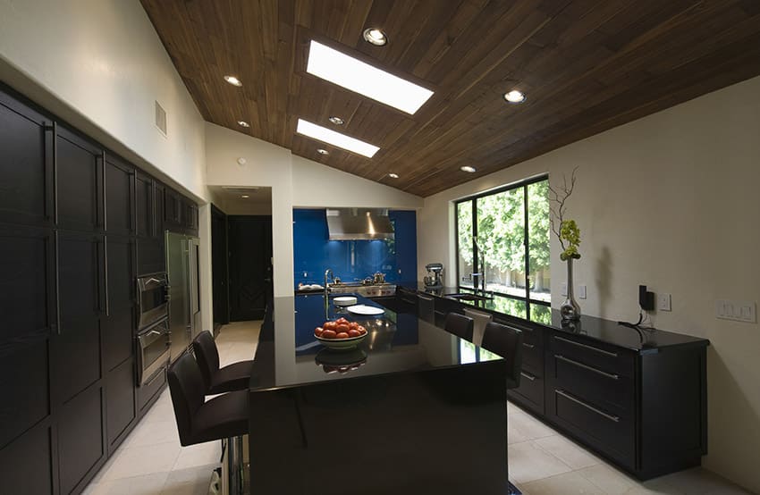 Modern wood kitchen with storage slanted ceiling and skylights