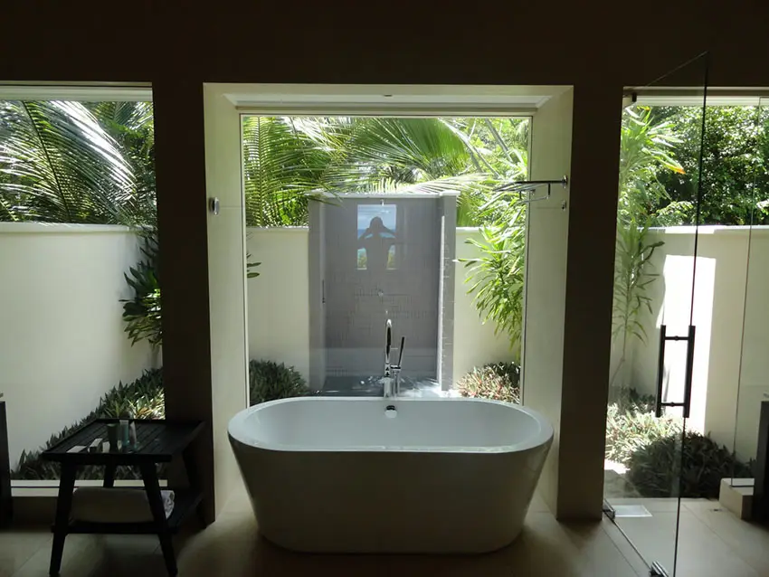 Private master bathroom suite with bathtub and garden view 