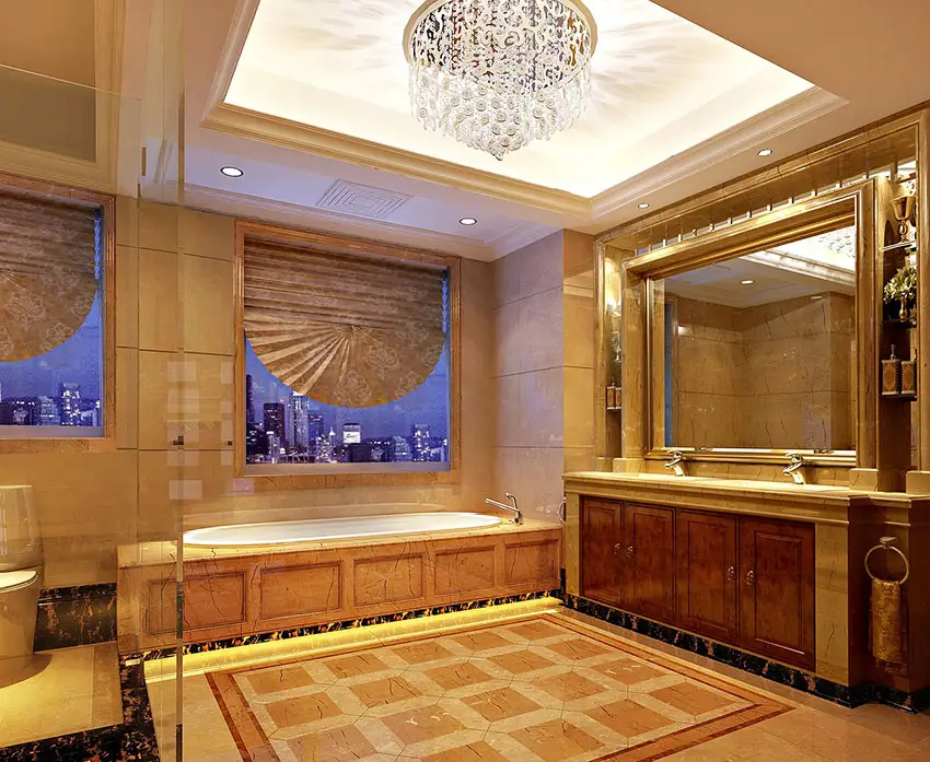 Regal gold bathroom design with glass light fixture city view