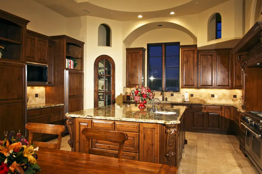 Rustic italian style kitchen with arched alcove with windows