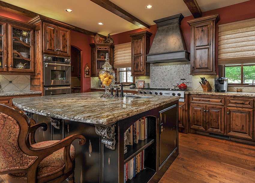 Rustic kitchen with black painted island with space for books and red walls