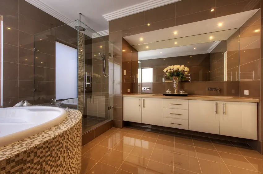 Sleek contemporary bathroom design in brown with tiled jacuzzi tub