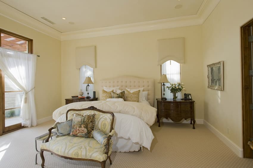 Light yellow walls in a Rococo inspired bedroom