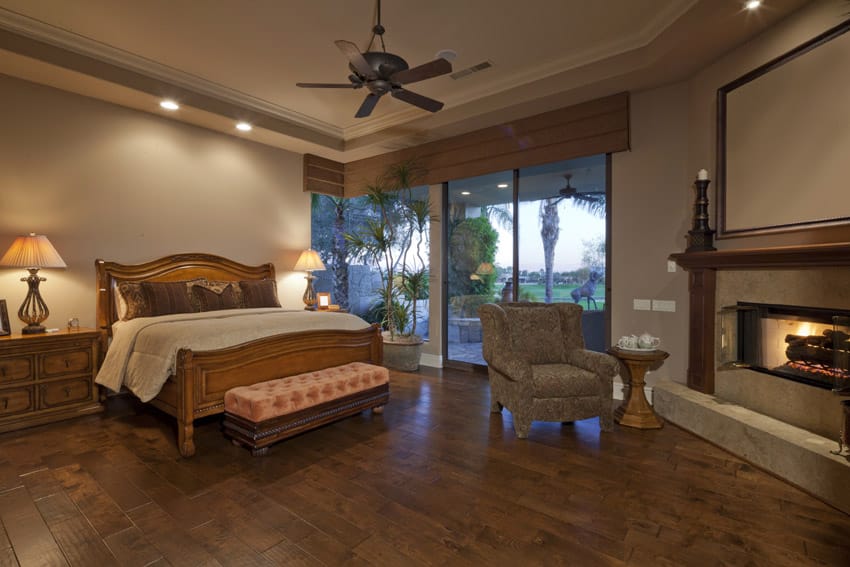 Wooden bed, night stand, ceiling fan and fireplace