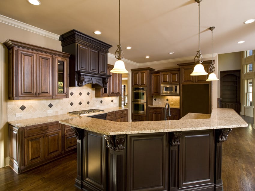 Two tone wood storage spaces and large island with mahogany stain