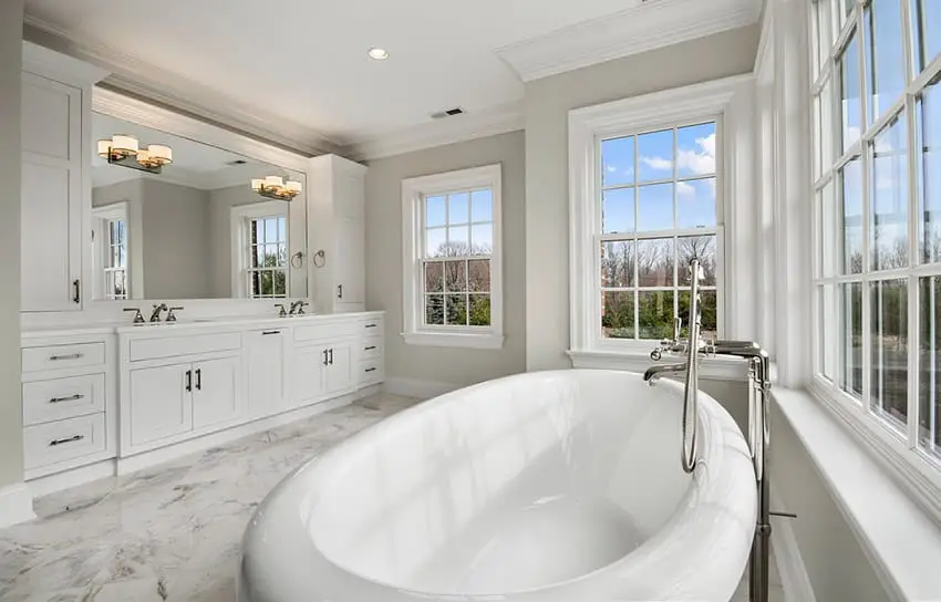 White marble bathroom with great lighting and windows