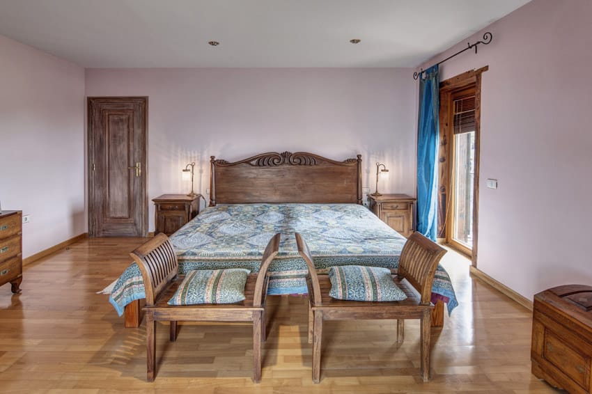 Bed with wooden headboard and blue bedcovers