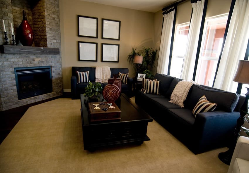 Dark sofa in room with tan area rug